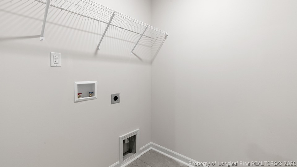 81 Discovery Way Spring Lake, NC 28390 - Photo 28 of 32 a view of storage and utility room with a washer dryer and white walls