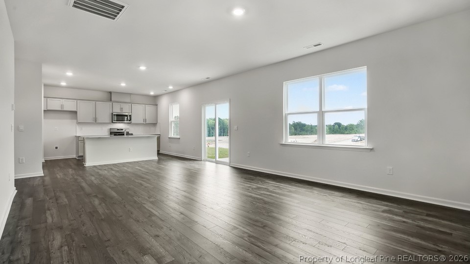 81 Discovery Way Spring Lake, NC 28390 - Photo 10 of 32 a kitchen with stainless steel appliances granite countertop a stove top oven a sink and a granite counter tops with wooden floors