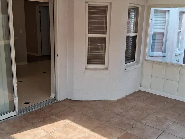 a view of a room that has wooden floor and a window
