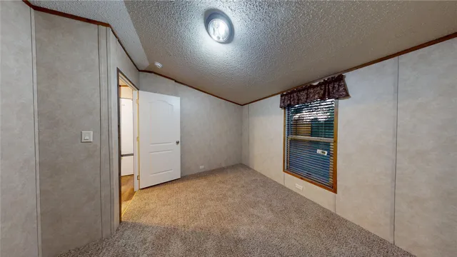 an empty room with an entryway and fire place