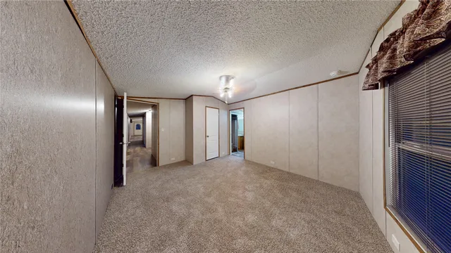 a bathroom with a granite countertop double vanity sink and mirror