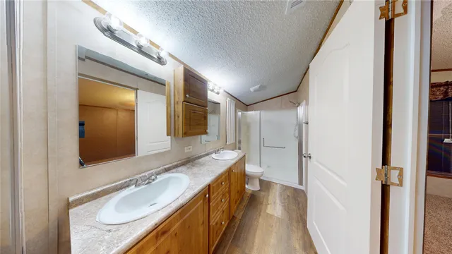 a bathroom with a granite countertop sink toilet and shower