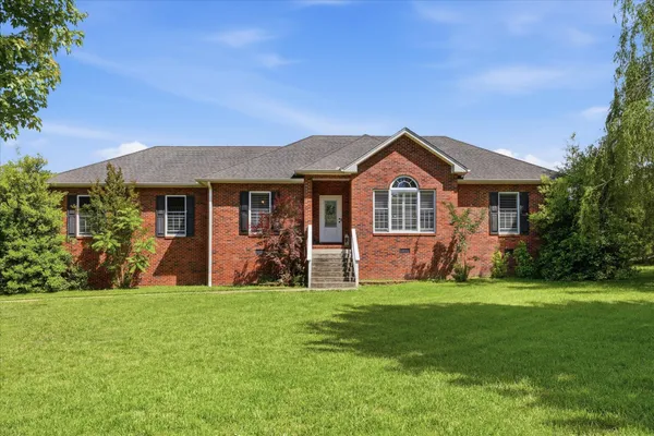a front view of a house with a yard