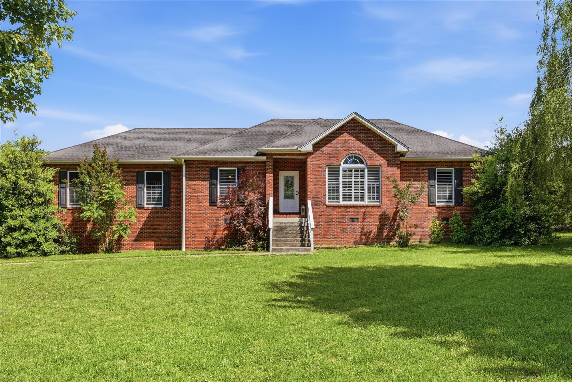 a front view of a house with a yard