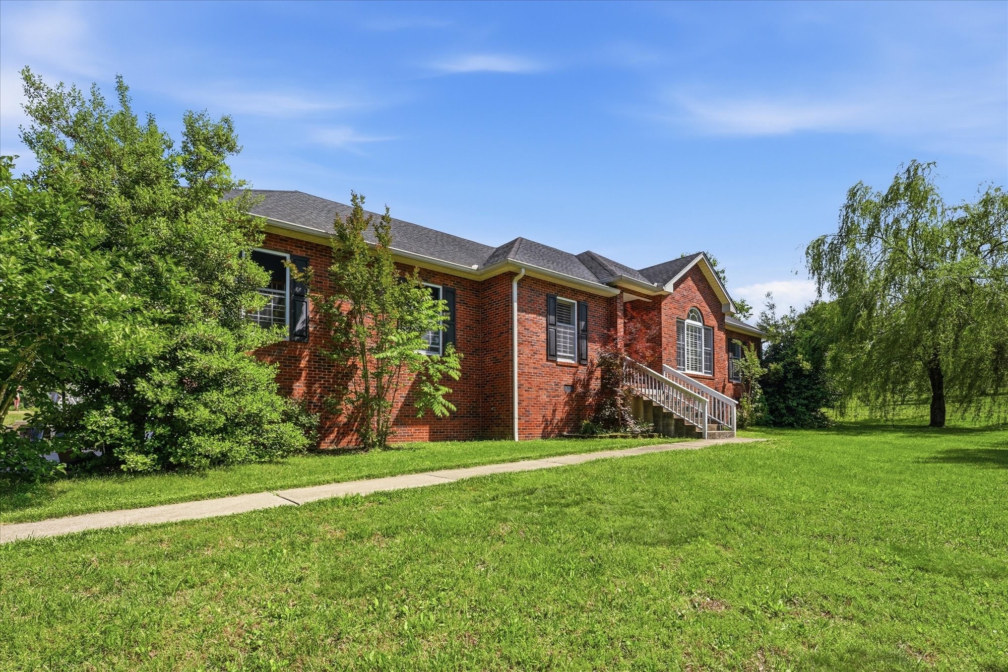 1510 Rapids Road Portland, TN 37148 - Photo 2 of 57 a view of a big house with a big yard and potted plants in front of the house