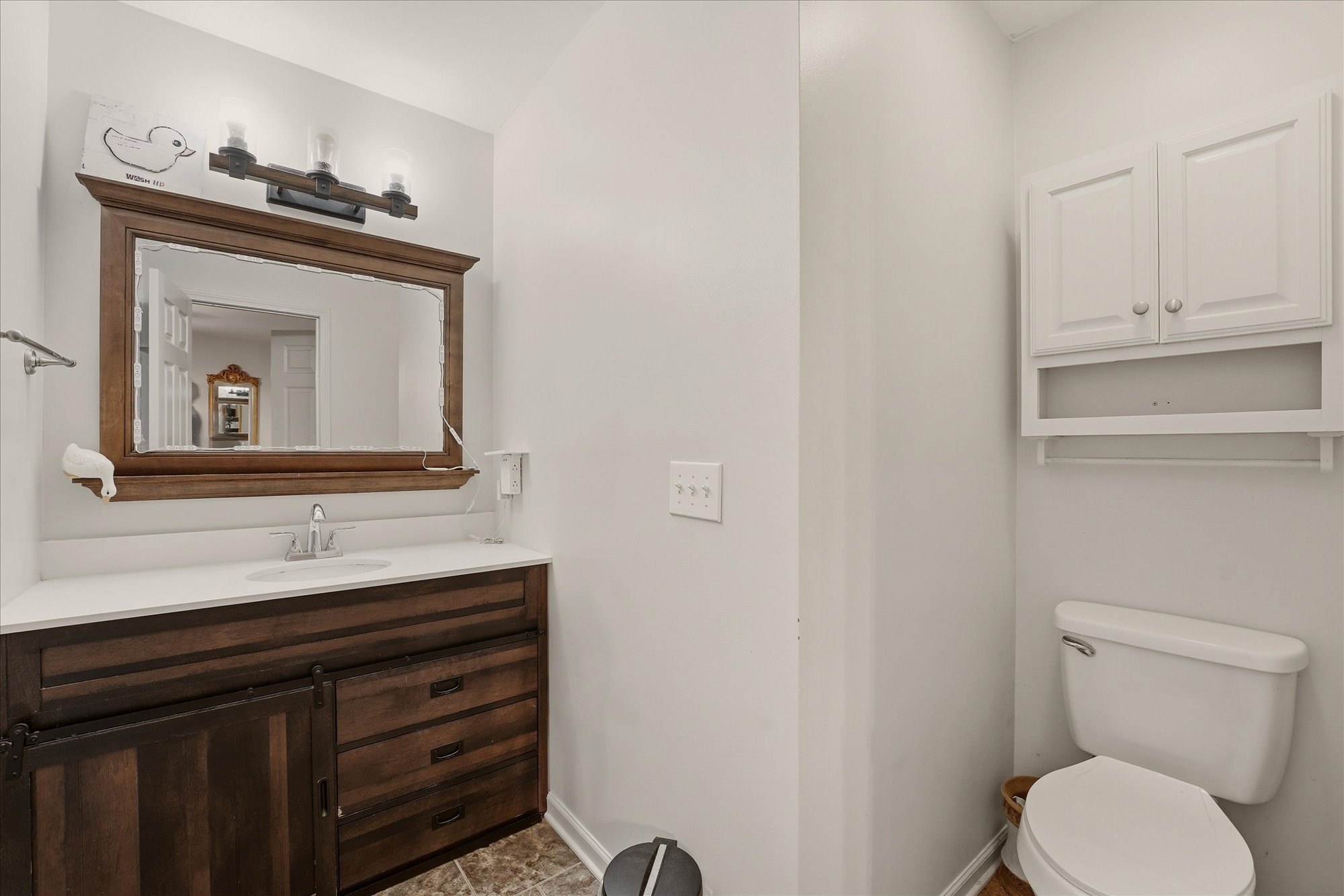 1510 Rapids Road Portland, TN 37148 - Photo 23 of 57 a bathroom with a toilet sink and mirror