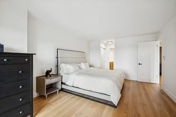 a bedroom with a bed and a dresser