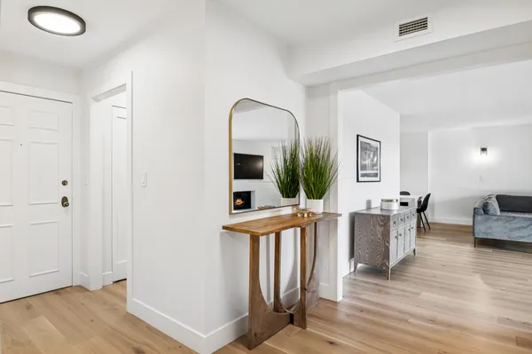 a view of a livingroom with furniture window and wooden floor