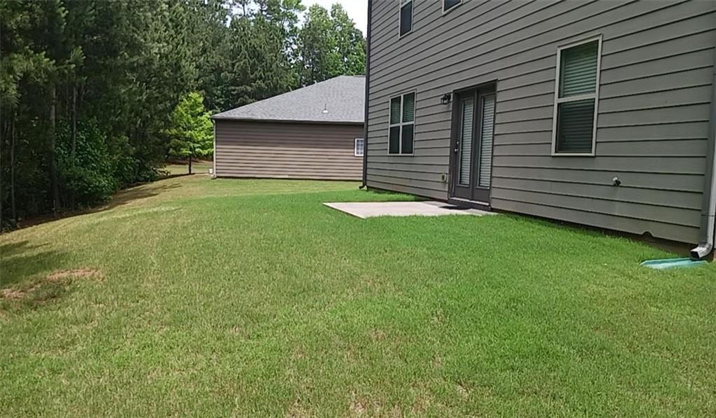 1033 Eldon Lane Fairburn, GA 30213 - Photo 21 of 21 a backyard of a house with lots of green space