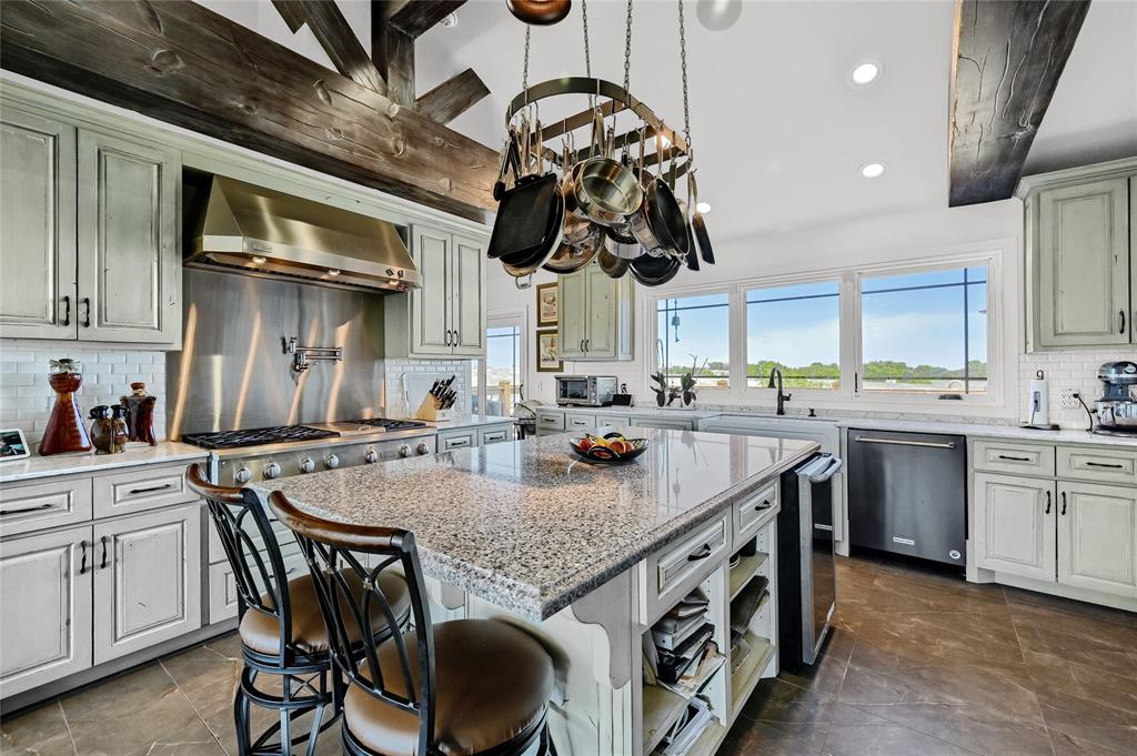 5555 County Road 179 Celina, TX 75009 - Photo 17 of 40 Kitchen featuring tasteful backsplash, wall chimney range hood, recessed lighting, light stone counters, and appliances with stainless steel finishes