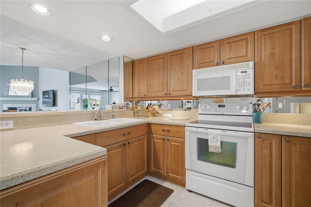 643 Garland Circle Indian Rocks Beach, FL 33785 - Photo 23 of 81 a kitchen with cabinets appliances a sink and a counter top space