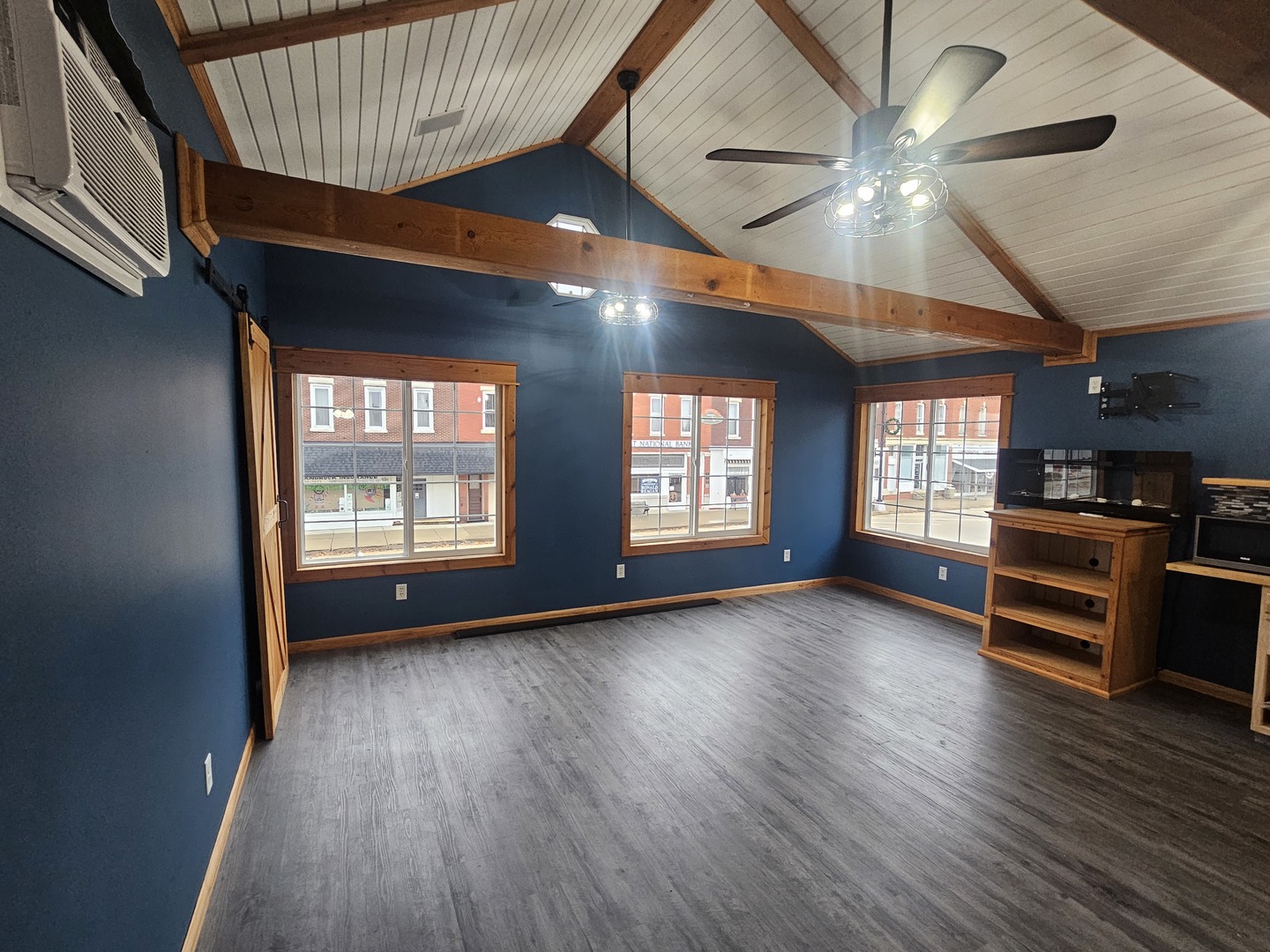 106 North Main Street Tampico, IL 61283 - Photo 3 of 16 a view of an empty room with a window and wooden floor