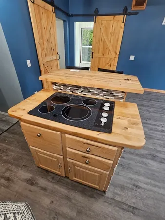 a stove top oven sitting inside of a kitchen