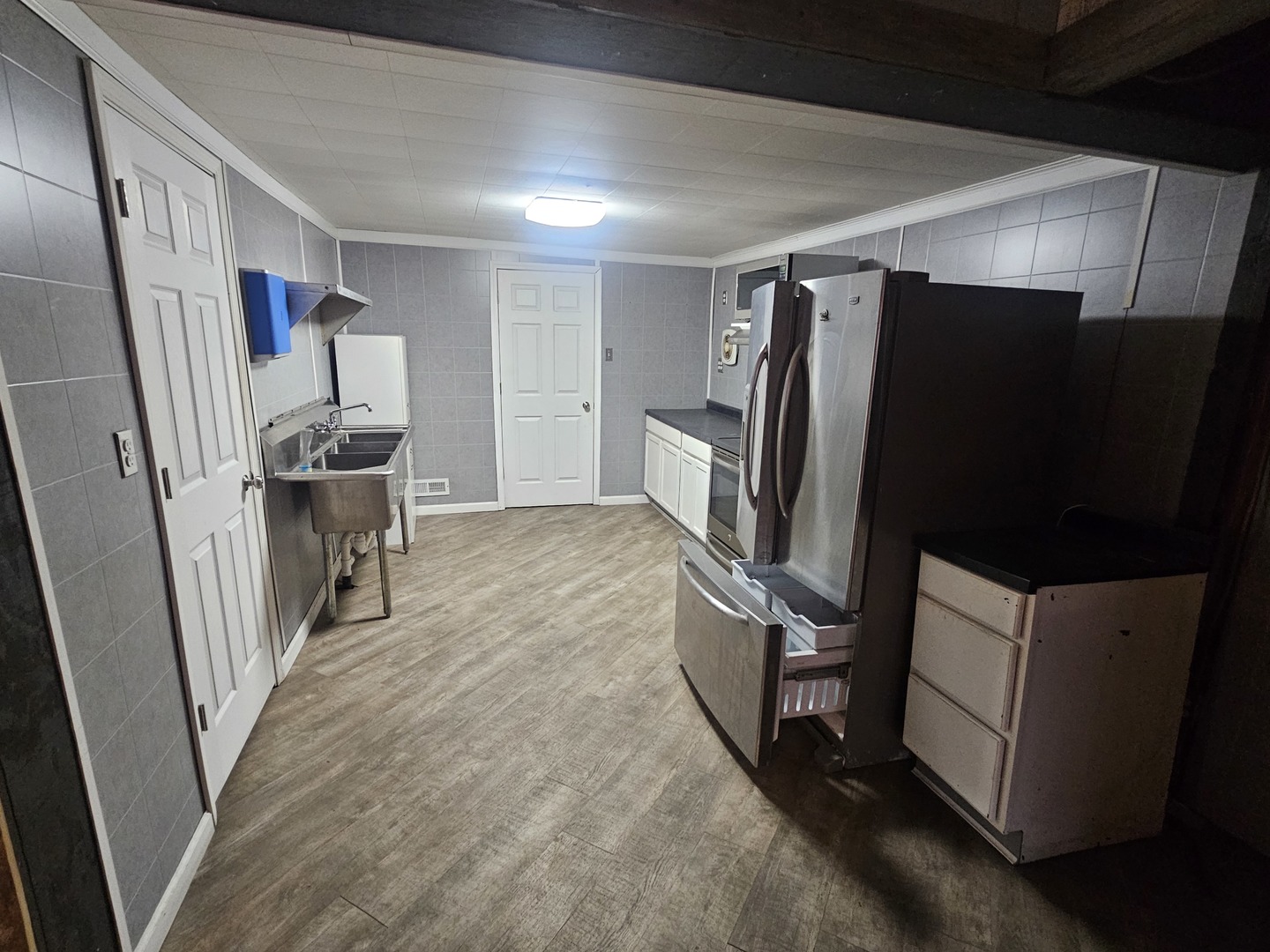 106 North Main Street Tampico, IL 61283 - Photo 9 of 16 a view of a refrigerator in kitchen and an empty room