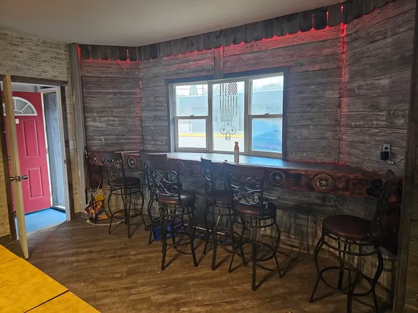 a view of a dining room with furniture and a window