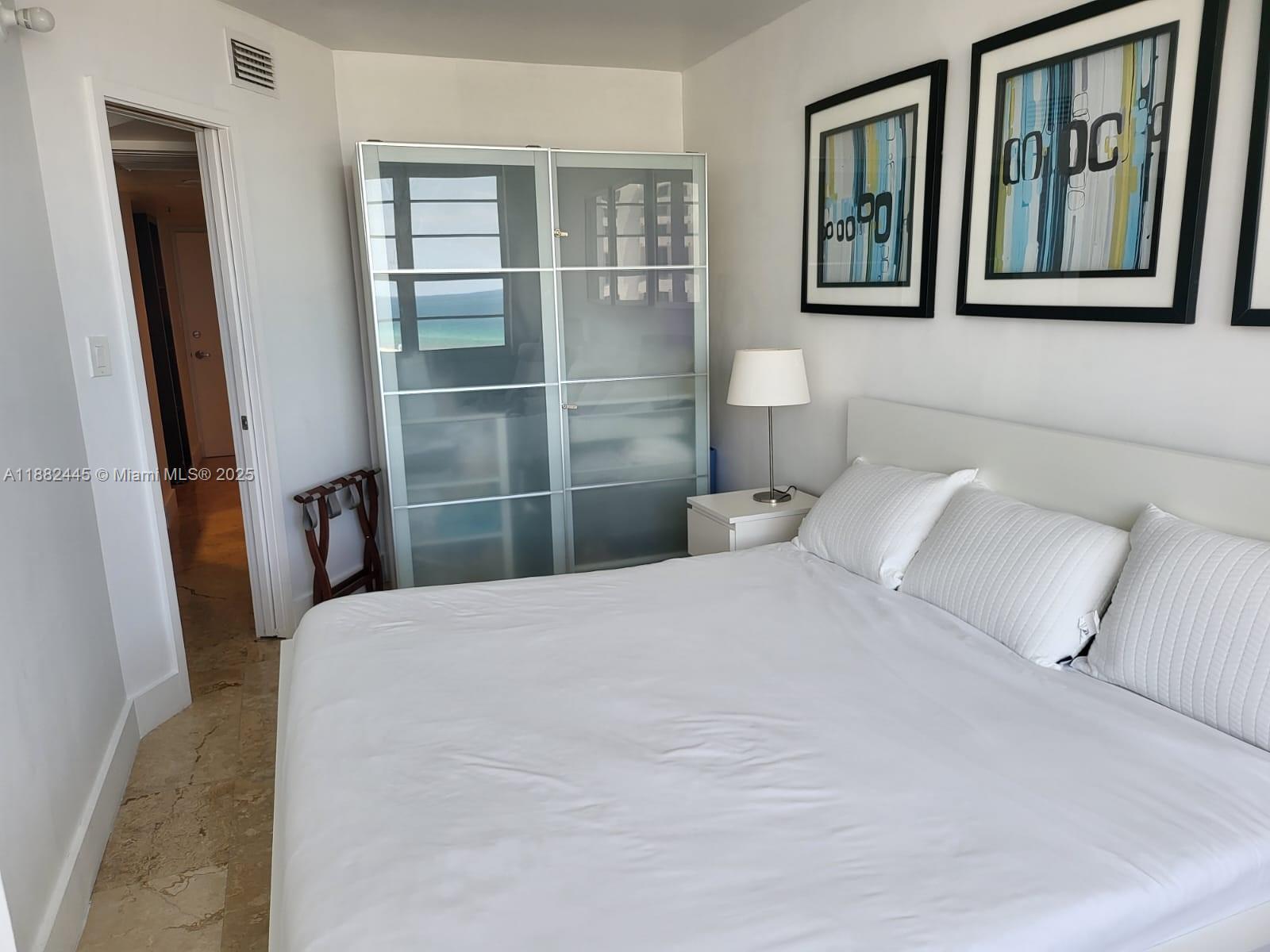 100 Lincoln Road, Unit 1238 Miami Beach, FL 33139 - Photo 26 of 31 a bedroom with a large bed and a window