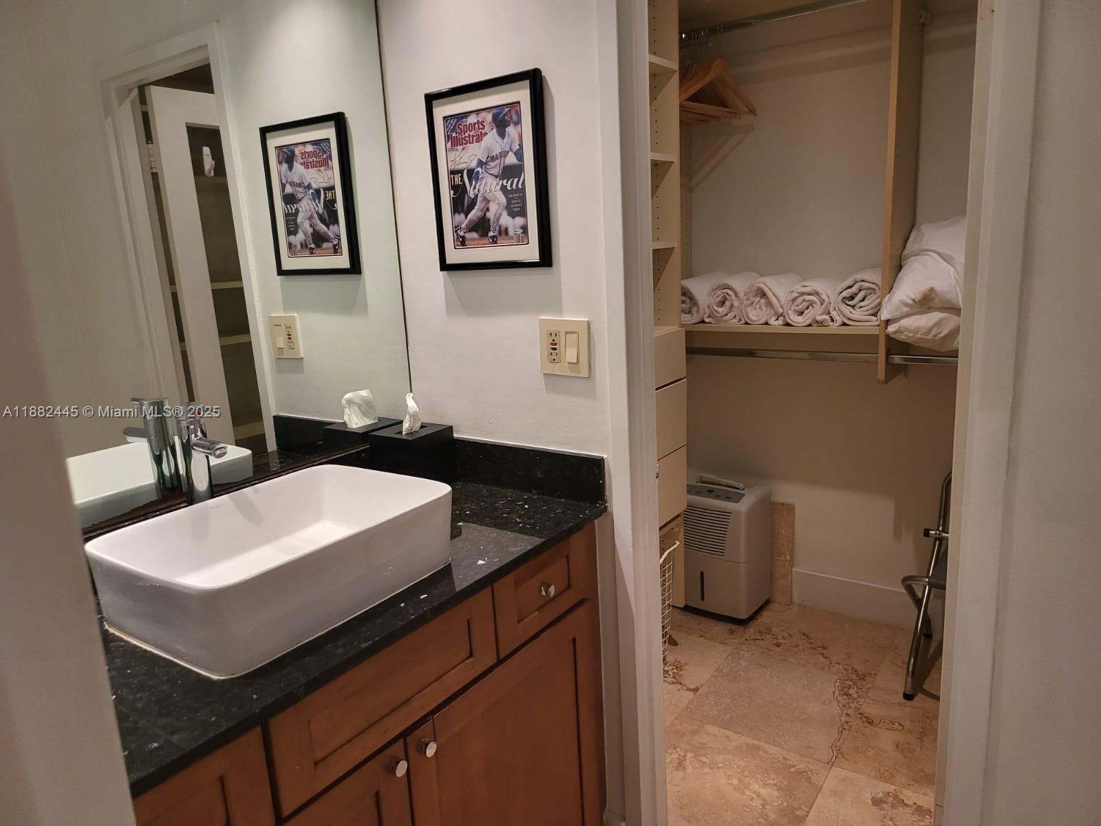100 Lincoln Road, Unit 1238 Miami Beach, FL 33139 - Photo 6 of 31 a bathroom with a granite countertop sink a toilet and mirror
