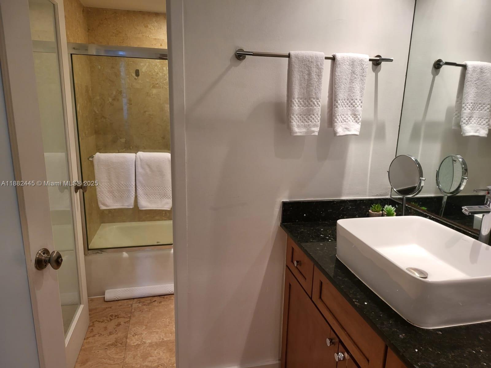 100 Lincoln Road, Unit 1238 Miami Beach, FL 33139 - Photo 7 of 31 a bathroom with a sink and mirror