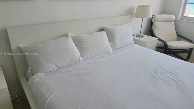 a room with a bed and a chair