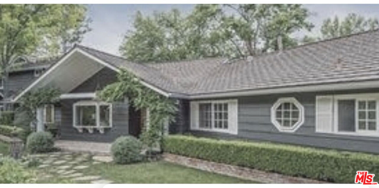 5657 Round Meadow Road Hidden Hills, CA 91302 - Photo 1 of 1 a front view of a house with garden