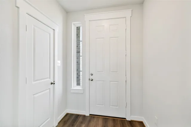 a view of front door with wooden floor
