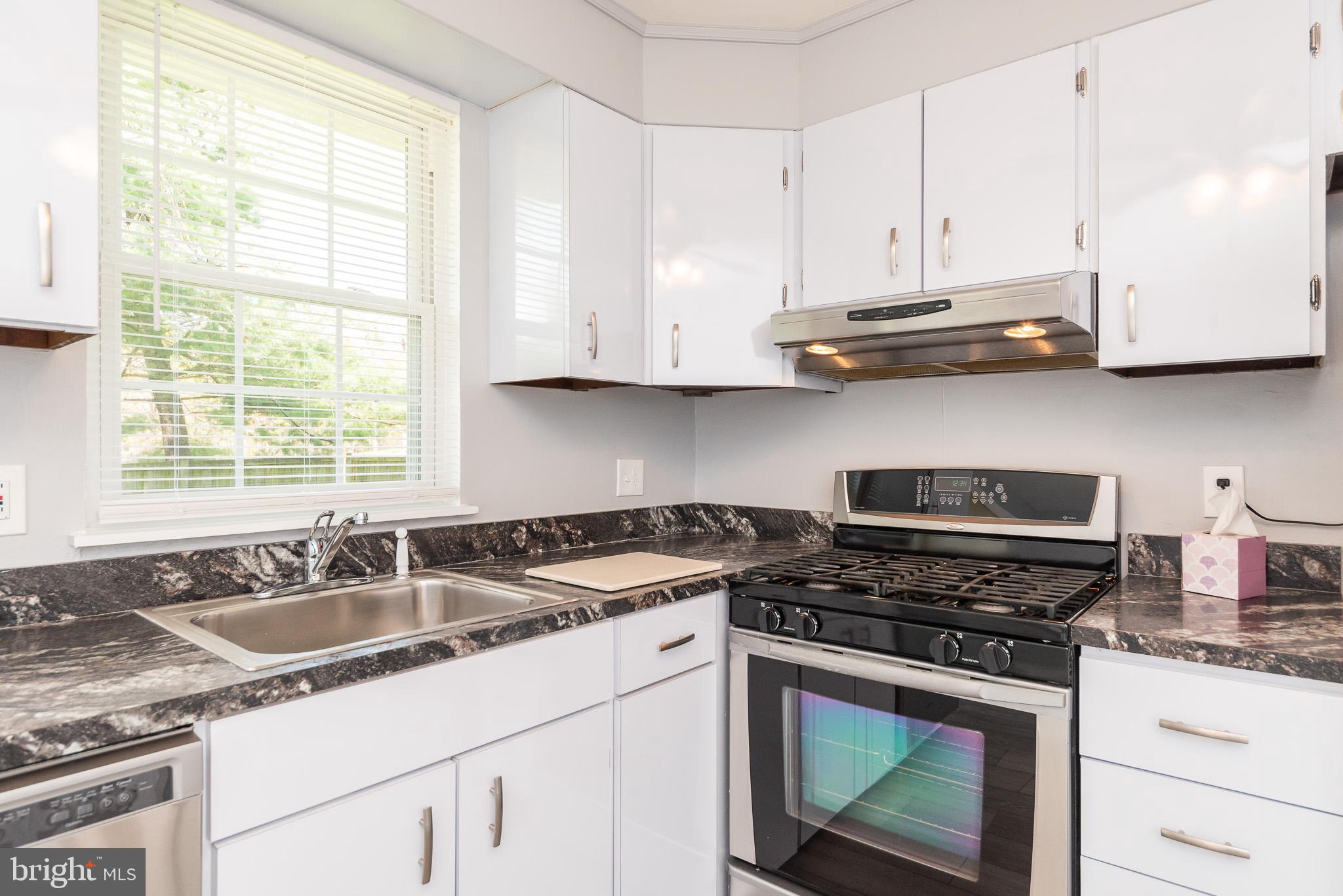 37 Cardor Court, Unit 37 Baltimore, MD 21236 - Photo 16 of 47 a kitchen with stainless steel appliances granite countertop white cabinets and a stove a sink