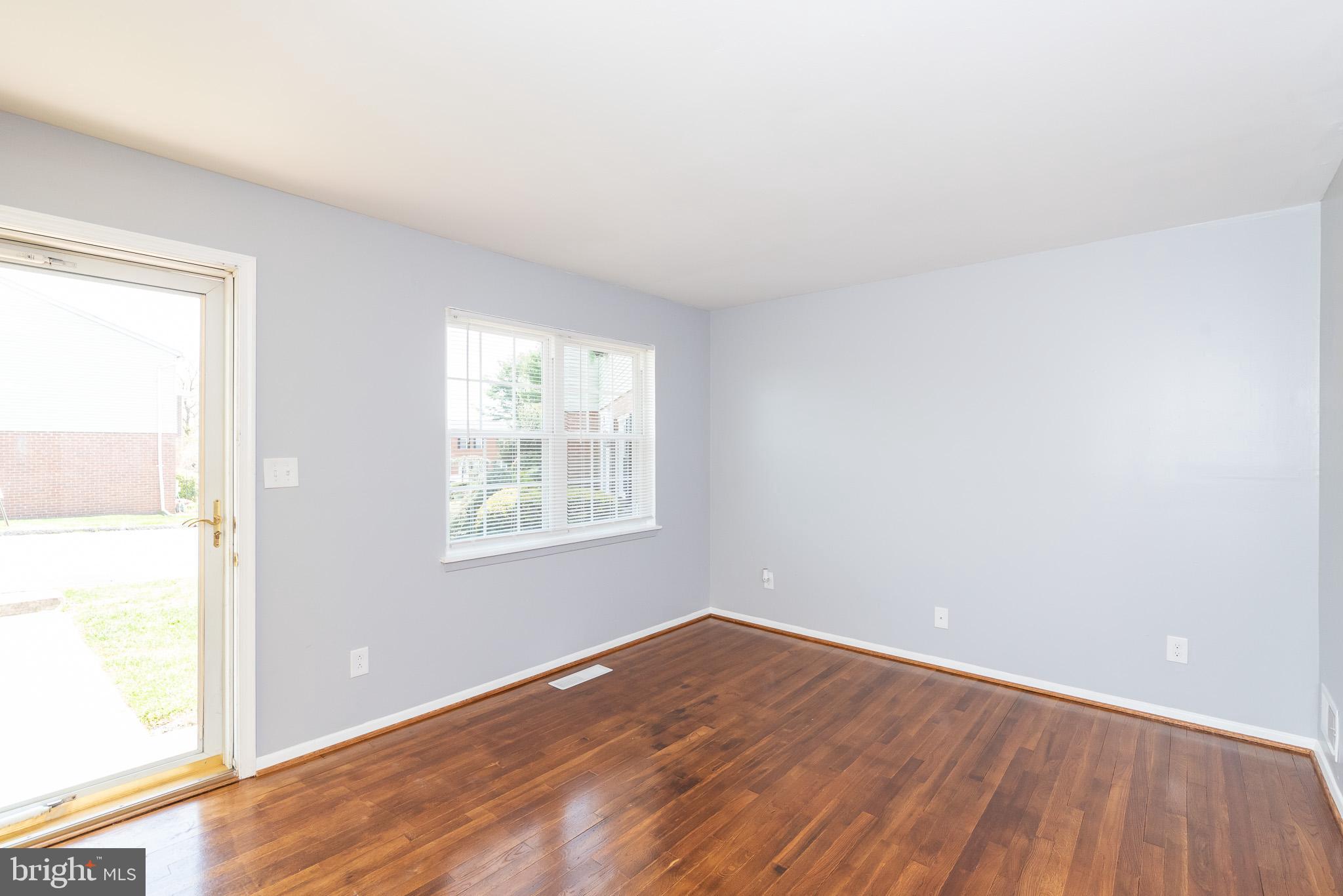 37 Cardor Court, Unit 37 Baltimore, MD 21236 - Photo 2 of 47 an empty room with wooden floor and windows