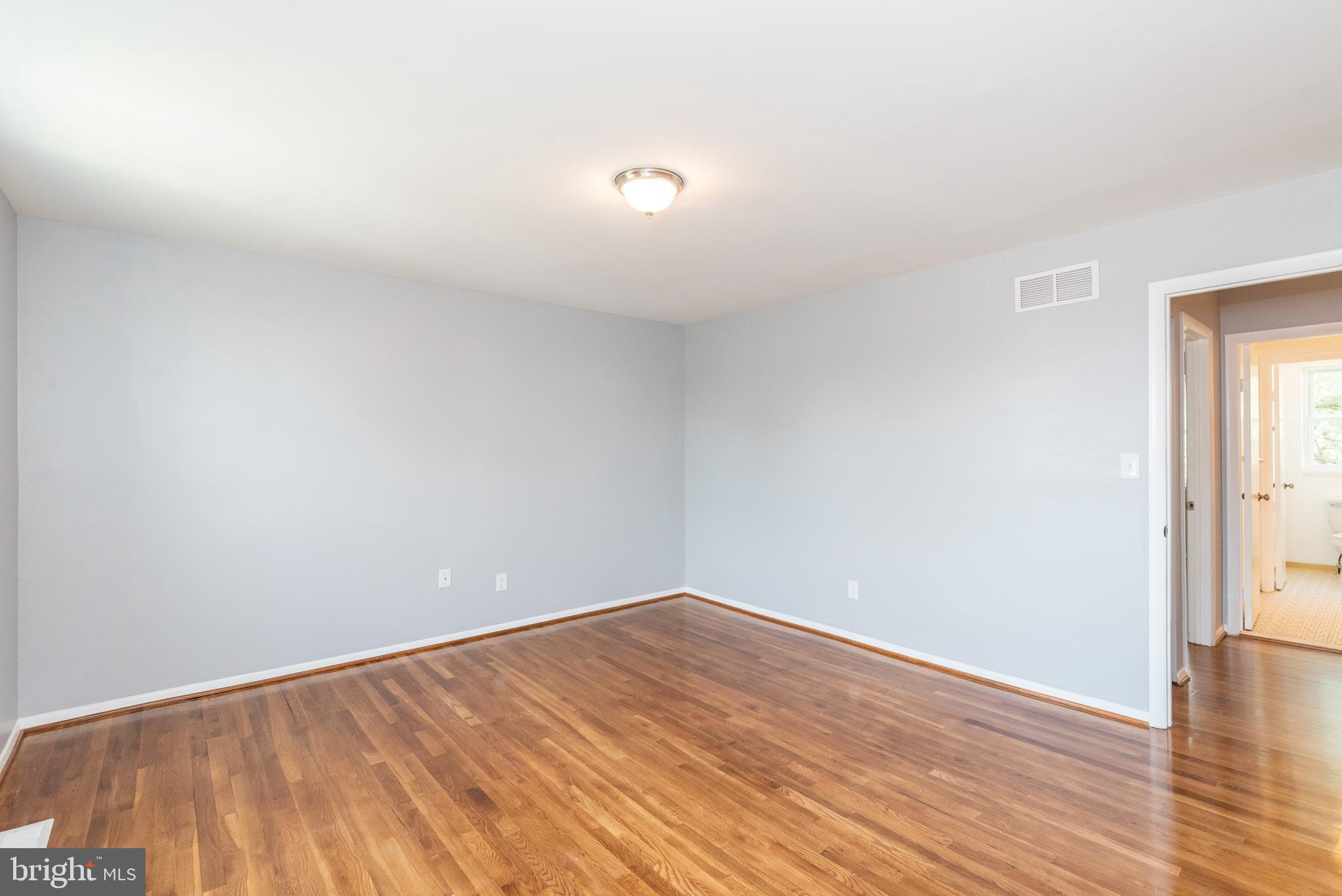 37 Cardor Court, Unit 37 Baltimore, MD 21236 - Photo 24 of 47 a view of an empty room with wooden floor and a window