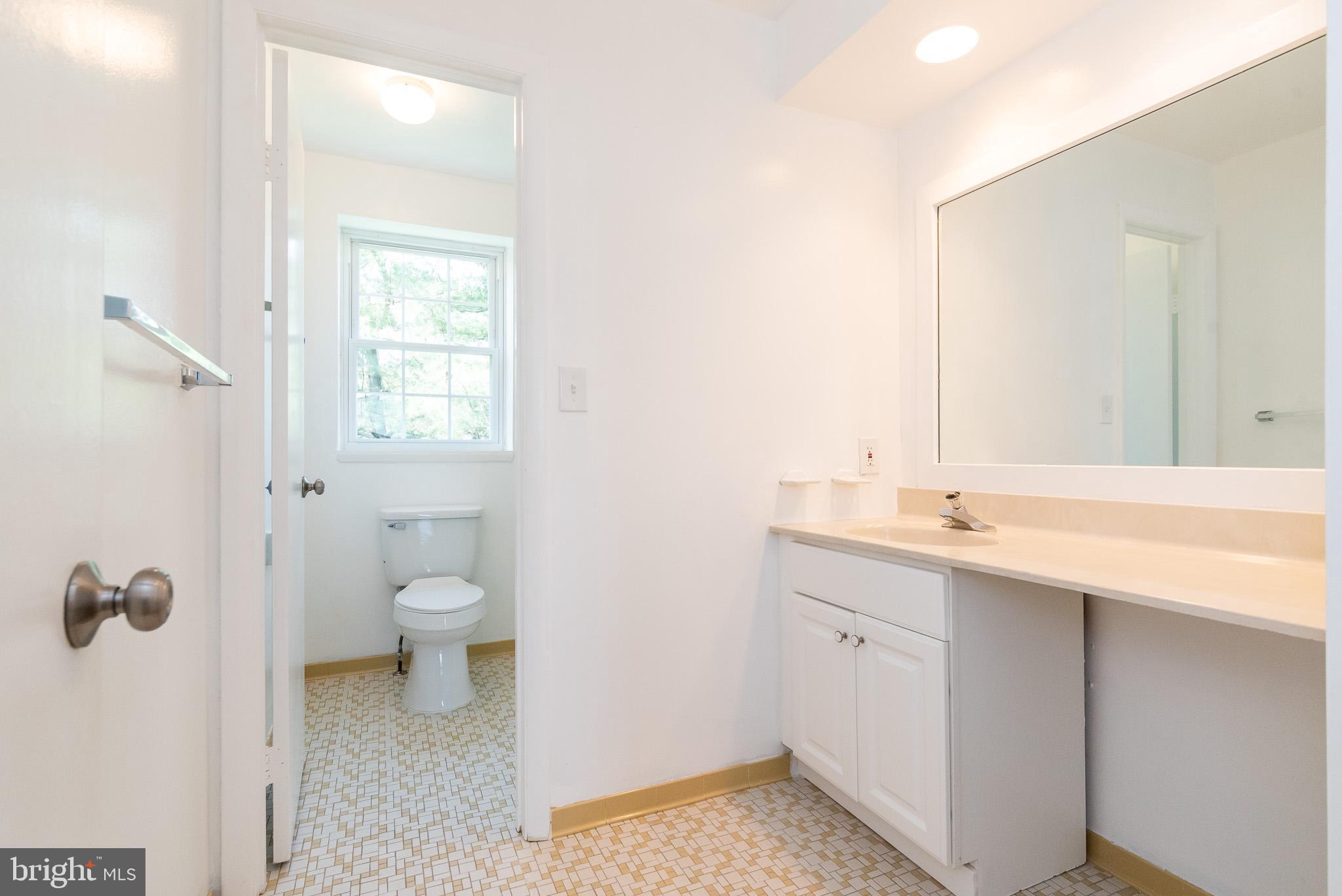 37 Cardor Court, Unit 37 Baltimore, MD 21236 - Photo 26 of 47 a bathroom with a sink a toilet and a mirror