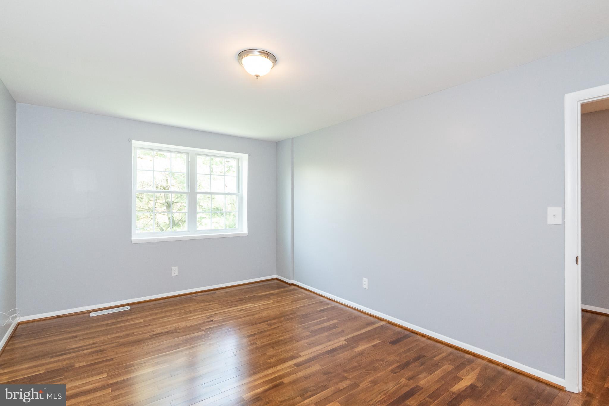 37 Cardor Court, Unit 37 Baltimore, MD 21236 - Photo 28 of 47 an empty room with wooden floor and windows