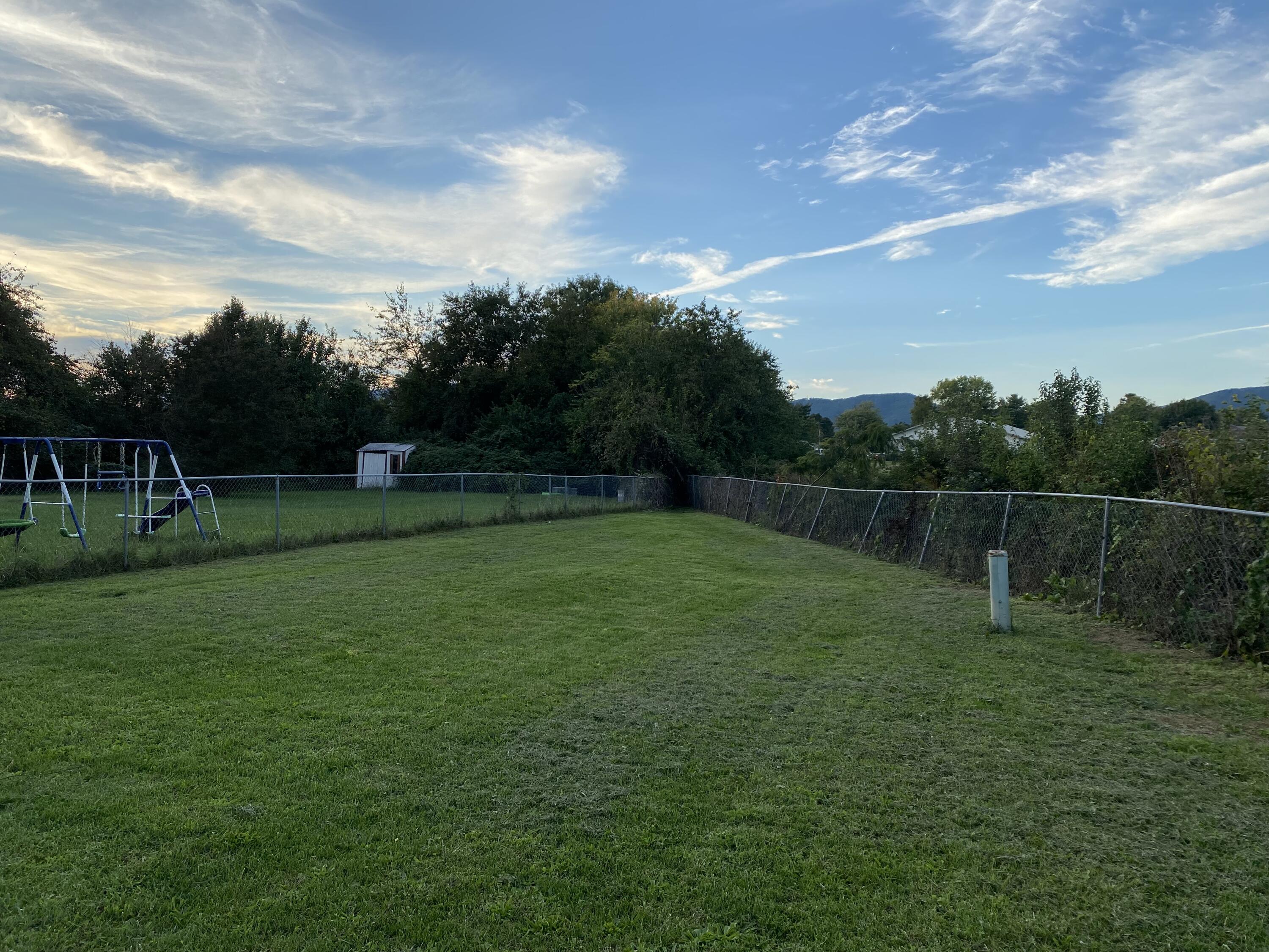 2312 Ranch Road Northwest Roanoke, VA 24017 - Photo 25 of 27 a backyard of a house with lots of green space and garden
