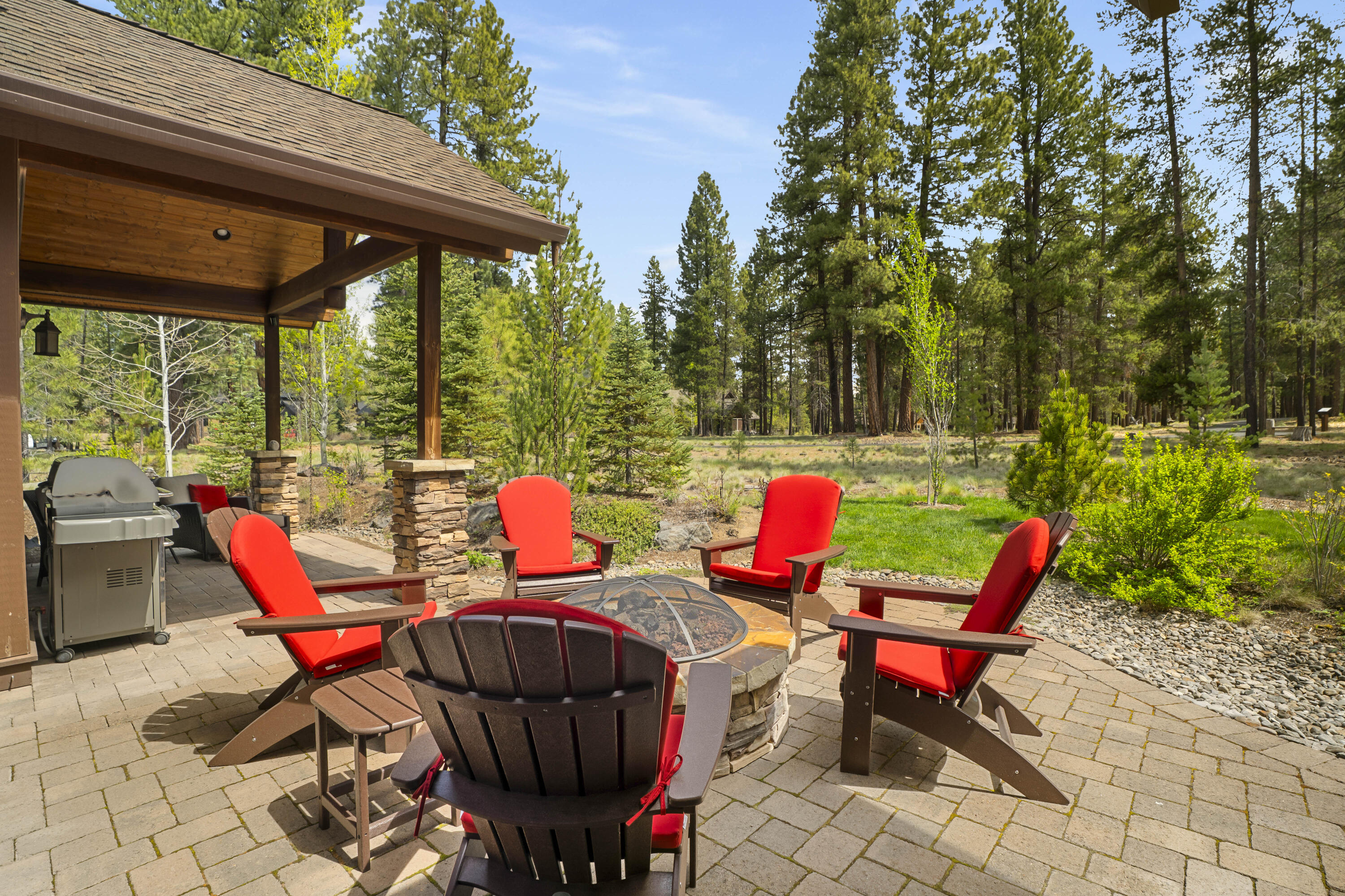56155 Sable Rock Loop, Unit 277 Bend, OR 97707 - Photo 4 of 63 Relax and unwind on the covered paver patio complete with a firepit seating area, hot tub and peaceful wooded views.