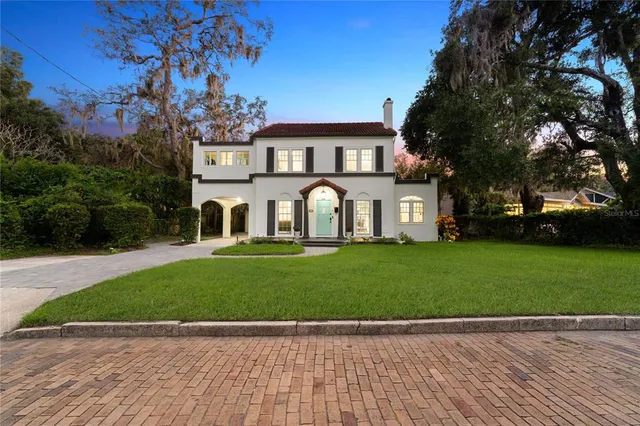 a front view of a house with a garden