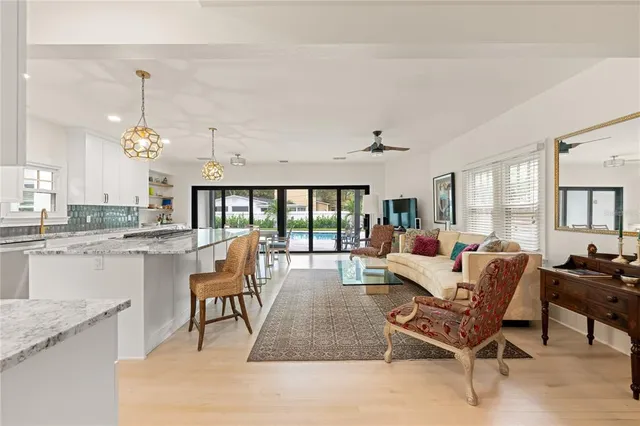 a living room with furniture a dining table and chairs