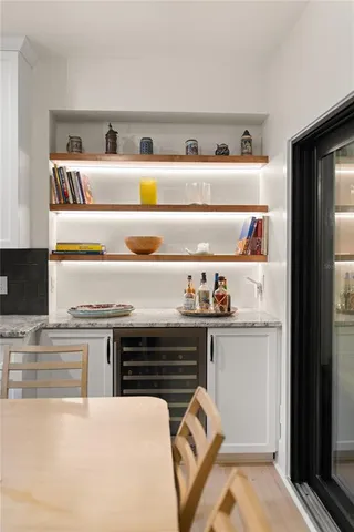 a kitchen with a dining table chairs and view kitchen