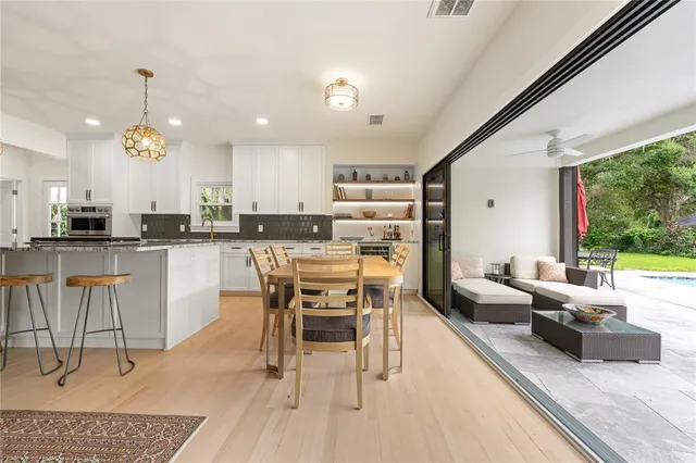 a living room with furniture and a floor to ceiling window