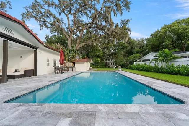 a view of a house with a yard and sitting area