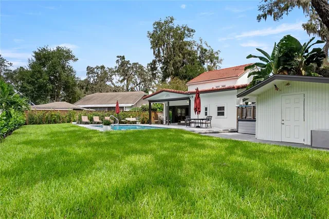 a view of a house with a yard porch and sitting area