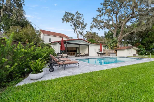 a view of house with swimming pool yard and outdoor seating