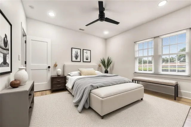 a bathroom with a granite countertop sink mirror vanity and toilet
