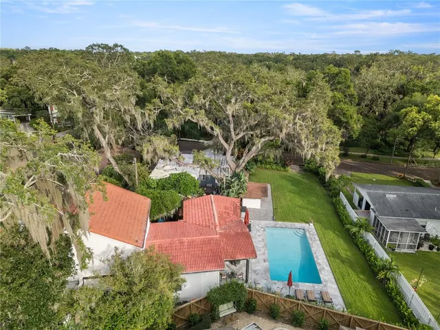 an aerial view of residential houses with outdoor space and river