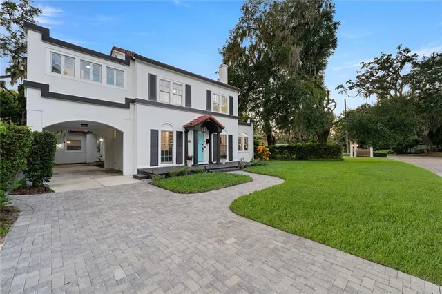 a kitchen with a table chairs sink and cabinets