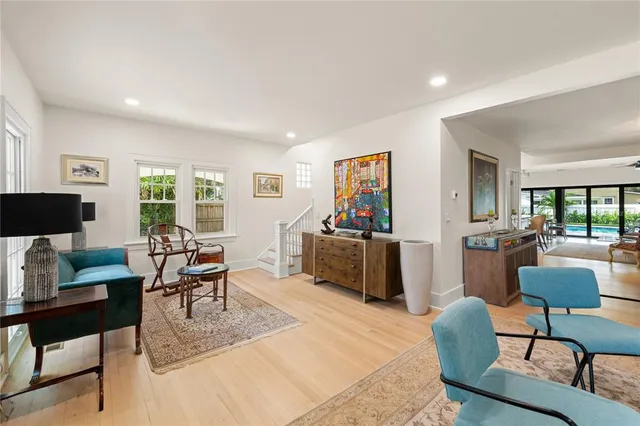 a living room with furniture a flat screen tv and a window