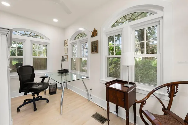 a view of a livingroom with workspace and a window