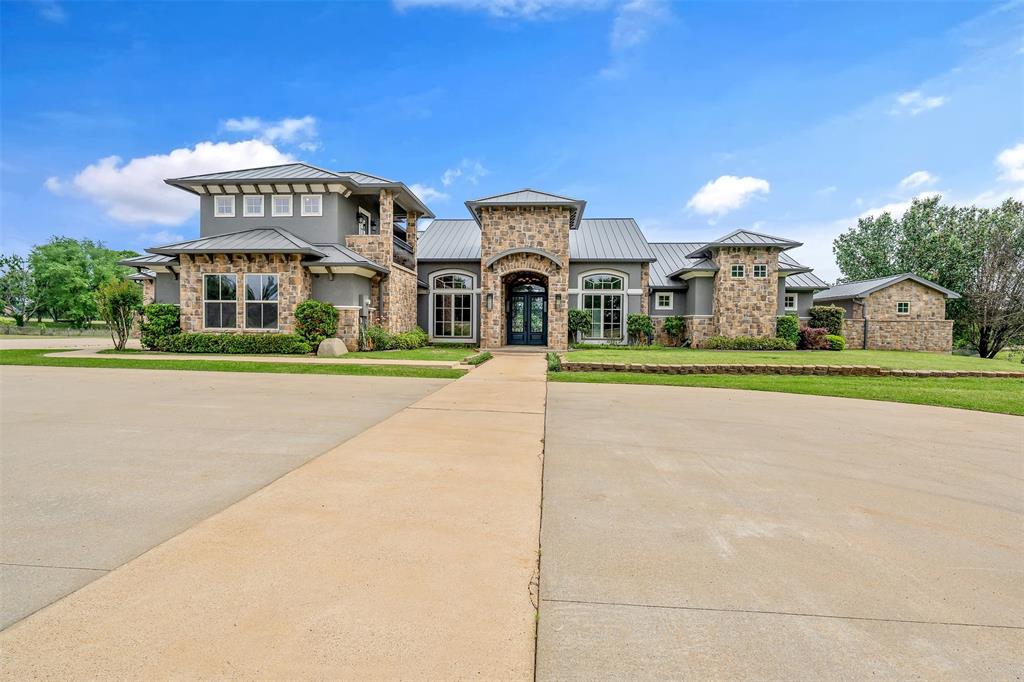 20389 County Road 178 Flint, TX 75762 - Photo 1 of 40 Contemporary-style residence featuring a stone and stucco exterior, prominent metal roofing, a grand double-door entry, and multiple large windows