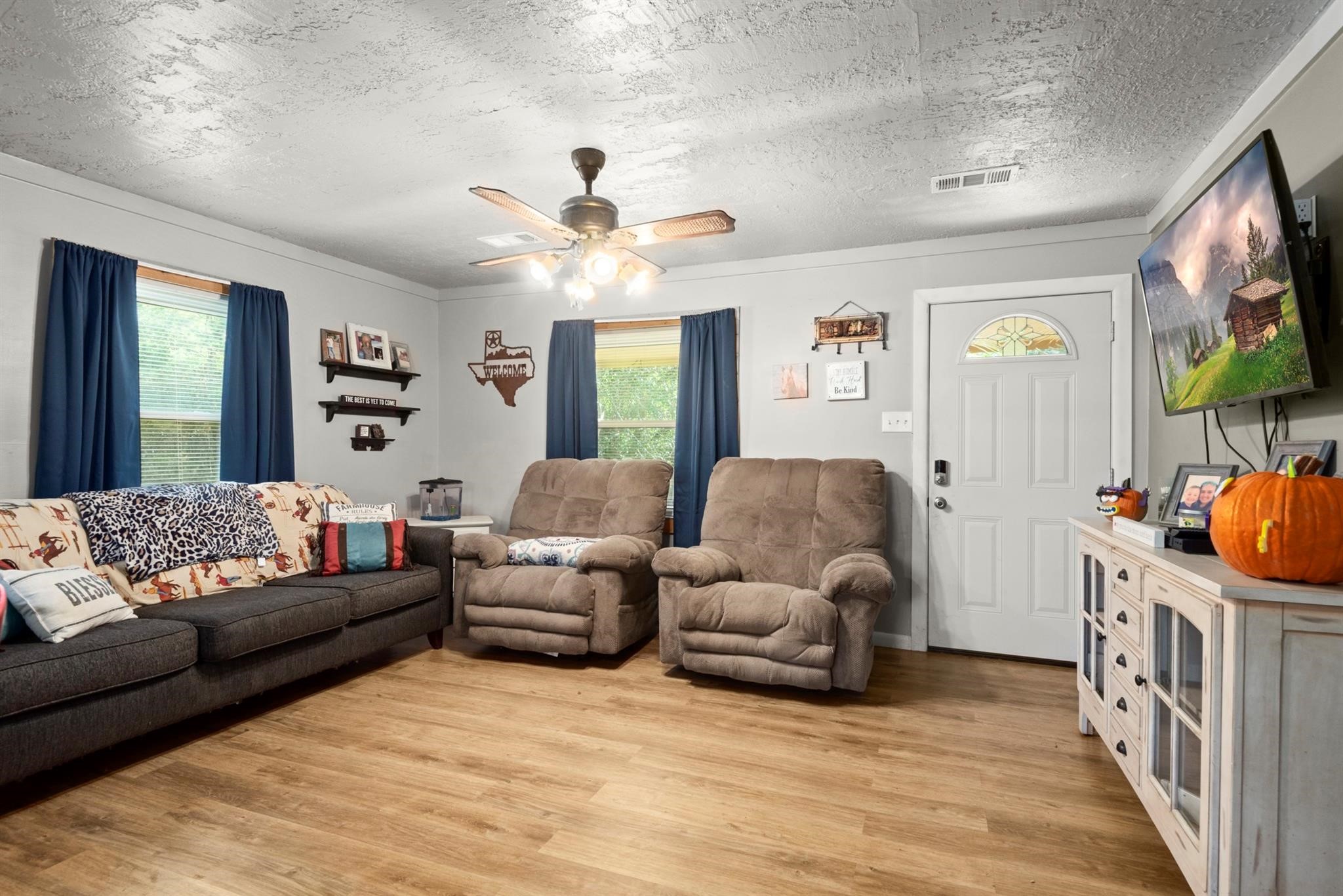 14676 Duke Road Splendora, TX 77372 - Photo 7 of 14 a living room with furniture and a flat screen tv