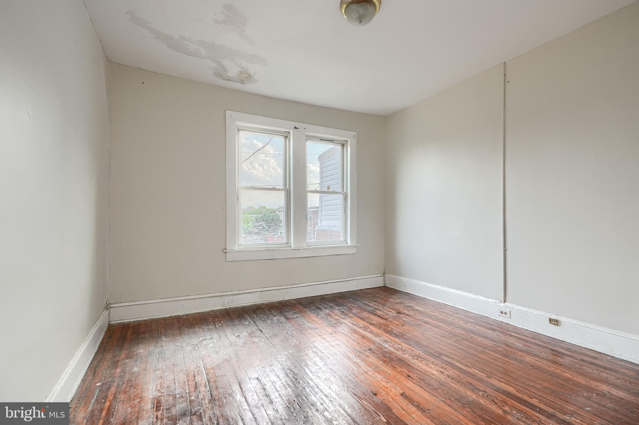 4806 Reisterstown Road Baltimore, MD 21215 - Photo 16 of 34 an empty room with wooden floor and windows