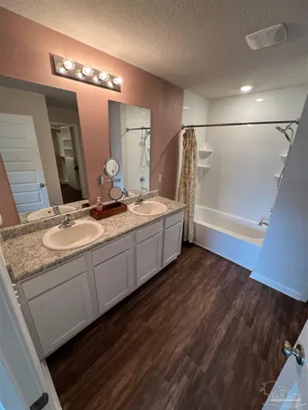 a bathroom with a double vanity sink and mirror