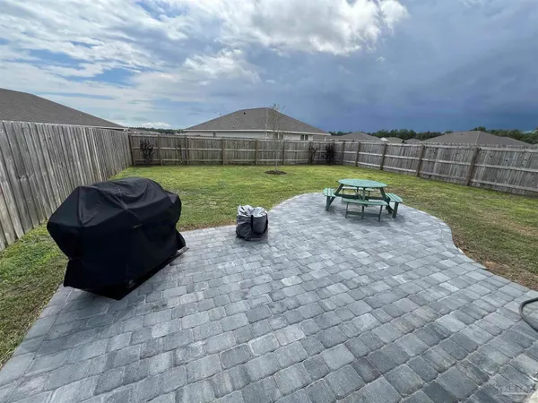 a view of a chairs and table in backyard