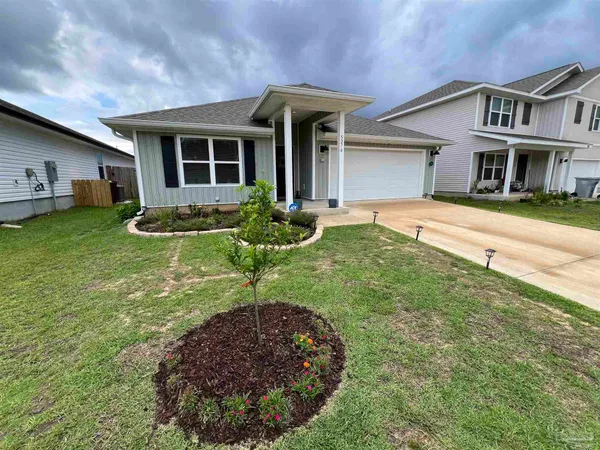a front view of a house with garden